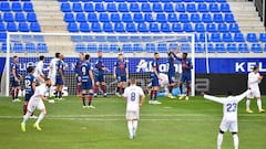 Real Madrid&#039;s players celebrate after scoring a goal during the Spanish league football match between SD Huesca and Real Madrid at the El Alcoraz stadium in Huesca on February 6, 2021. (Photo by Pau BARRENA / AFP)