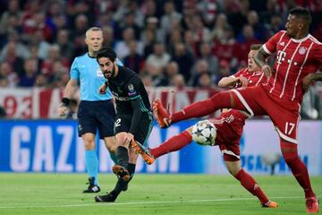 Real Madrid's Spanish midfielder Isco vies with Bayern Munich's Arturo Vidal and Jerome Boateng during the UEFA Champions League semi-final first-leg.