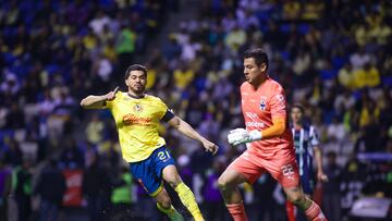 Henry Martin (L) of America fights for the ball with Luis Cardenas (R) of Monterrey during the final first-leg match between America and Monterrey as part of the Torneo Apertura 2024 Liga MX at Cuauhtemoc Stadium, on December 12, 2024 in Puebla, Mexico.