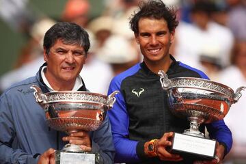 Rafael Nadal of Spain celebrates victory with the trophy alongside coach Toni Nadal after the men's singles final against Stan Wawrinka of Switzerland on day fifteen of the French Open at Roland Garros on June 11, 2017 in Paris, France.