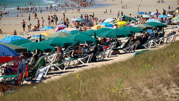 Varias personas se refugian del sol bajo sombrillas, a 7 de agosto de 2023, en Pontevedra, Galicia (España).  El lunes por la tarde empezarán las alertas por altas temperaturas debido a esta ola de calor en Galicia. Se prevé que la situación empeore el martes a partir de la una de la tarde. Para entonces está previsto el nivel naranja de alerta en comarcas como Ourense y O Ribeiro por ejemplo, mientras que el nivel amarillo estará vigente en prácticamente todo el país incluida zonas costeras como las Rías Baixas.
07 AGOSTO 2023;PLAYA;CALOR;VERANO;AGUA;ARENA;SOMBRILLA;
Elena Fernández / Europa Press
07/08/2023