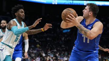 Oct 13, 2021; Charlotte, North Carolina, USA; Dallas Mavericks guard Luka Doncic (77) looks to the basket guarded by Charlotte Hornets forward Jalen McDaniels (6) during the first half at Spectrum Center. Mandatory Credit: Jim Dedmon-USA TODAY Sports