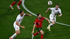 Czech Republic's midfielder #22 Tomas Soucek (L) and Portugal's midfielder #10 Bernardo Silva (C) fights for the ball during the UEFA Euro 2024 Group F football match between Portugal and the Czech Republic at the Leipzig Stadium in Leipzig on June 18, 2024. (Photo by GABRIEL BOUYS / AFP)