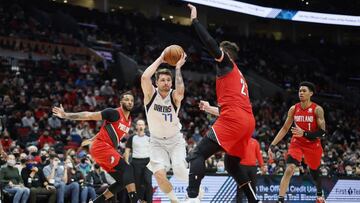 Jan 26, 2022; Portland, Oregon, USA; Dallas Mavericks point guard Luka Doncic (77) drives to the basket against Portland Trail Blazers Center Jusuf Nurkic (27) during the second half at Moda Center. Mandatory Credit: Soobum Im-USA TODAY Sports