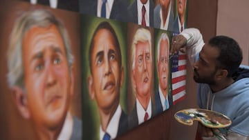 A painter gives the final touches to a painting depicting newly elected US President Joe Biden, in Amritsar on November 8 ,2020. (Photo by NARINDER NANU / AFP)