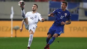 PIRAEUS, GREECE - NOVEMBER 12: Kostas Fortounis of Greece and Mario Mandzukic of Croatia in action during the FIFA 2018 World Cup Qualifier Play-Off: Second Leg between Greece and Croatia at Karaiskakis Stadium on November 12, 2017 in Piraeus, . (Photo