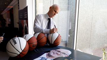 Head coach Dan Hurley of the Connecticut Huskies signs autographs.