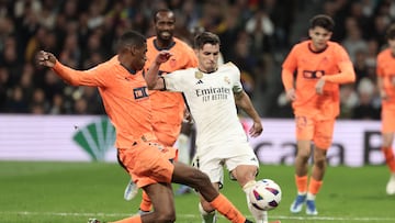 Valencia's Spanish defender #03 Cristhian Mosquera (L) tackles Real Madrid's Spanish forward #21 Brahim Diaz during the Spanish league football match between Real Madrid CF and Valencia CF at the Santiago Bernabeu stadium in Madrid on November 11, 2023. (Photo by Thomas COEX / AFP)