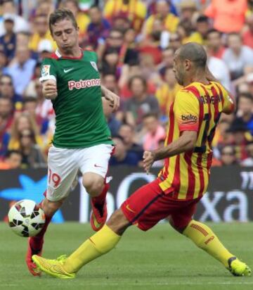 Javier Mascherano (d), del FC Barcelona, intenta avanzar con el balón ante la presencia de Muniain (i), del Athletic de Bilbao, durante el partido de Liga jugado esta tarde en el Camp Nou de Barcelona.