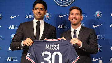 Soccer Football - Lionel Messi Press Conference after signing for Paris St Germain - Parc des Princes, Paris, France - August 11, 2021 Paris St Germain&#039;s Lionel Messi and president Nasser Al-Khelaifi pose with a shirt after the press conference REUTE