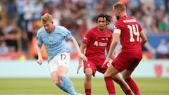 Kevin De Bruyne of Manchester City controls the ball under pressure from Trent Alexander-Arnold (C) and Jordan Henderson of Liverpool (R)