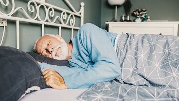 Senior men waking up in the morning in bed