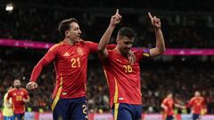 Spain's midfielder #16 Rodri celebrates scoring his team's third goal with Spain's forward #21 Mikel Oyarzabal during the international friendly football match between Spain and Brazil at the Santiago Bernabeu stadium in Madrid on March 26, 2024. Spain arranged a friendly against Brazil at the Santiago Bernabeu under the slogan "One Skin" to help combat racism. (Photo by Thomas COEX / AFP)