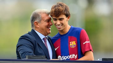 Portuguese forward Joao Felix (R) shakes hands with FC Barcelona president Joan Laporta during his official presentation as new player of FC Barcelona at the Joan Gamper training ground in Sant Joan Despi, near Barcelona, on September 2, 2023. Barcelona signed Atletico Madrid forward Joao Felix and Manchester City defender Joao Cancelo on loan until the end of the season. (Photo by Pau BARRENA / AFP)