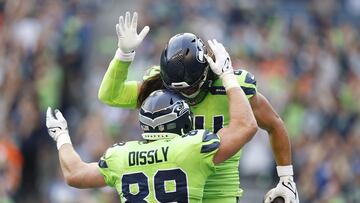 SEATTLE, WASHINGTON - SEPTEMBER 12: Will Dissly #89 and Colby Parkinson #84 of the Seattle Seahawks celebrate a touchdown scored by Parkinson during the second quarter against the Denver Broncos at Lumen Field on September 12, 2022 in Seattle, Washington.   Steph Chambers/Getty Images/AFP