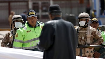 A man talks with a policeman at the border between Peru and Bolivia after Peru's government's announcement of border closure in a bid to slow the spread of the new coronavirus (COVID-19), in Desaguadero, Bolivia, March 17, 2020. REUTERS/David Me
