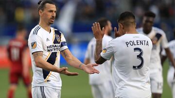CARSON, CALIFORNIA - APRIL 28: Zlatan Ibrahimovic #9 is congratualted by Diego Polenta #3 of Los Angeles Galaxy after scoring a goal during the second half of a game against the Real Salt Lake at Dignity Health Sports Park on April 28, 2019 in Carson, California.   Sean M. Haffey/Getty Images/AFP
 == FOR NEWSPAPERS, INTERNET, TELCOS &amp; TELEVISION USE ONLY ==