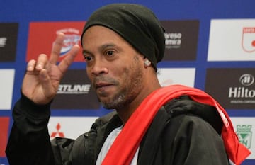 Brazilian former footballer Ronaldinho Gaucho gestures during a press conference in Bogota on October 16, 2019.