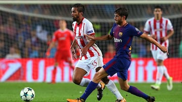 Soccer Football - Champions League - FC Barcelona vs Olympiacos - Camp Nou, Barcelona, Spain - October 18, 2017 Olympiacos' Mehdi Carcela-Gonzalez in action with Barcelona’s Sergi Roberto REUTERS/Albert Gea