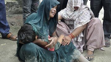 SENSITIVE MATERIAL. THIS IMAGE MAY OFFEND OR DISTURB A woman is consoled as she mourns after her son died in a stampede outside a hospital in Hathras district in the northern state of Uttar Pradesh, India, July 2, 2024. REUTERS/Stringer  BEST QUALITY AVAILABLE