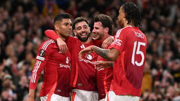 Manchester United's Brazilian midfielder #18 Casemiro (L) celebrates with teammates after scoring Manchester United's second goal during the UEFA Europa League semi final second leg football match between Manchester United and Athletic Club Bilbao at Old Trafford stadium in Manchester, north west England, on May 8, 2025. (Photo by Oli SCARFF / AFP)