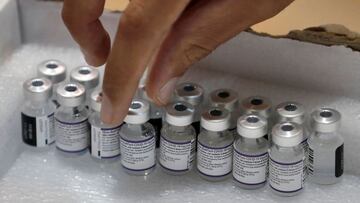 A paramedic with Israel&#039;s Magen David Adom medical service gets a vial of the Pfizer-BioNTech Covid-19 vaccine on August 24, 2021 at a vaccination centre in Holon.