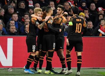 Soccer Football - Champions League - Group H - Ajax Amsterdam v Valencia - Johan Cruijff Arena, Amsterdam, Netherlands - December 10, 2019 Valencia's Rodrigo celebrates scoring their first goal with teammates REUTERS/Piroschka van de Wouw