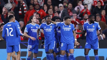 Real Madrid's Brazilian forward #07 Vinicius Junior (C,L) celebrates with teammates scoring his team's first goal during the UEFA Champions League knockout round play-off first leg football match between SL Benfica and Real Madrid CF at Estadio da Luz in Lisbon on February 17, 2026. (Photo by FILIPE AMORIM / AFP)