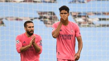 Real Madrid&#039;s French defender Raphael Varane (R) reacts after Manchester City&#039;s English midfielder Raheem Sterling (unseen) scored his team&#039;s first goal during the UEFA Champions League round of 16 second leg football match between Manchest