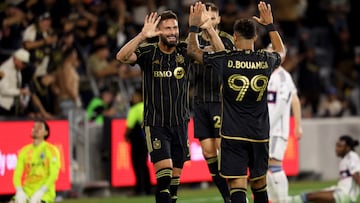 Oct 27, 2024; Los Angeles, California, USA; LAFC forward Olivier Giroud (9) celebrates with forward Denis Bouanga (99) after a goal during the second half in a 2024 MLS Cup Playoffs Round One match against the Vancouver Whitecaps FC at BMO Stadium. Mandatory Credit: Kiyoshi Mio-Imagn Images