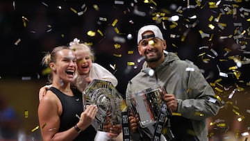 Tennis - 'Battle of the Sexes' - Nick Kyrgios v Aryna Sabalenka - Coca-Cola Arena, Dubai, United Arab Emirates - December 28, 2025 Belarus' Aryna Sabalenka, her goddaughter Nicole, and Australia's Nick Kyrgios celebrate with trophies after the match REUTERS/Amr Alfiky/Pool