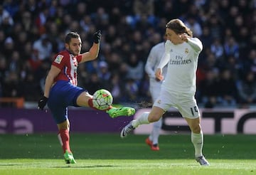 Atlético's Koke Resurreccion clashes with Luka Modric during the local derby.