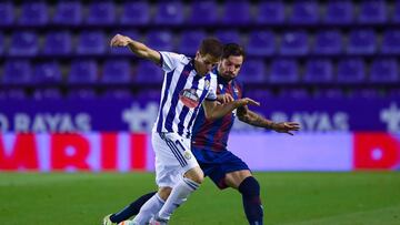 VALLADOLID, SPAIN - JULY 01: Pablo Hervias of Real Valladolid CF competes for the ball with &#039;To&ntilde;o&#039; Garcia of Levante UD during the Liga match between Real Valladolid CF and Levante UD at Jose Zorrilla on July 01, 2020 in Valladolid, Spain