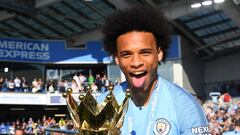 BRIGHTON, ENGLAND - MAY 12: Leroy Sane of Manchester City celebrates with the Premier League Trophy after winning the title during the Premier League match between Brighton &amp; Hove Albion and Manchester City at American Express Community Stadium on May