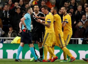 Juventus' Gianluigi Buffon and team mates remonstrate with referee Michael Oliver after he awarded a penalty to Real Madrid.