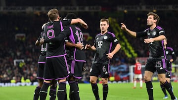 Bayern Munich's players celebrate the opening goal scored by Bayern Munich's French forward #11 Kingsley Coman during the UEFA Champions League group A football match between Manchester United and FC Bayern Munich at Old Trafford stadium in Manchester, north west England, on December 12, 2023. (Photo by PETER POWELL / AFP)