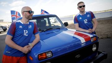 Kristbjorn Hilmir Kjartansson (R) and Gretar Jonsson, Iceland's supporters, pose for a picture with their Lada after a journey from home to Russia to watch their team against Nigeria, in Volgograd, Russia June 20, 2018. REUTERS/Ueslei Marcelino