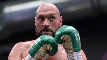 (FILES) In this file photo taken on April 19, 2022 World Boxing Council (WBC) heavyweight title holder Britain's Tyson Fury takes part in an open work-out session in Wembley, west London. - WBC heavyweight champion Tyson Fury said he is retiring from boxing on his 34th birthday on August 12, 2022, having previously performed a number of U-turns over his future in the sport. "After long hard conversations I've finally decided to walk away & on my 34th birthday I say Bon voyage," Fury posted on Twitter. (Photo by JUSTIN TALLIS / AFP)