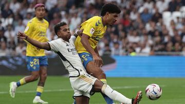 Real Madrid's Brazilian forward #11 Rodrygo (L) fights for the ball with Las Palmas'  Equatorial Guinean-Spanish defender #23 Saul Coco during the Spanish league football match between Real Madrid CF and UD Las Palmas at the Santiago Bernabeu stadium in Madrid on September 27, 2023. (Photo by Thomas COEX / AFP)