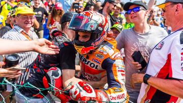 Spanish Honda rider Marc Marquez celebrates with supporters after winning the Moto GP race at the Grand Prix of Germany at the Sachsenring Circuit on July 15, 2018 in Hohenstein-Ernstthal, eastern Germany. / AFP PHOTO / Robert MICHAEL