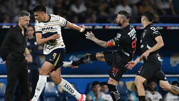 TOPSHOT - Pumas' forward #09 Guillermo Martinez is fouled by Monterrey's Spanish defender #93 Sergio Ramos during the Liga MX Clausura football match between Pumas and Monterrey at the Olimpico Universitario stadium in Mexico City on March 16, 2025. (Photo by Yuri CORTEZ / AFP)