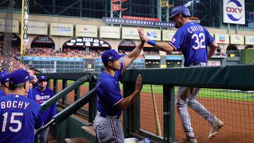 HOUSTON, TEXAS - OCTOBER 15: Evan Carter #32 of the Texas Rangers is congratulated by associate manager Will Venable #83 after Carter scored a run on a single hit by Jonah Heim #28 (not pictured) in the second inning against the Houston Astros during Game One of the American League Championship Series at Minute Maid Park on October 15, 2023 in Houston, Texas.   Carmen Mandato/Getty Images/AFP (Photo by Carmen Mandato / GETTY IMAGES NORTH AMERICA / Getty Images via AFP)