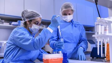 BELO HORIZONTE, BRAZIL - MARCH 24: Andressa Parreiras, Biomedic, and Larissa Vuitika, biologist, work in a laboratory during the extraction of the virus genetic material on March 24, 2020 in Belo Horizonte, Brazil. The Ministry of Health convened The Tech