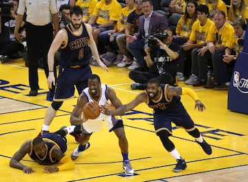 June 2, 2016; Oakland, CA, USA; Golden State Warriors forward Harrison Barnes (40) passes the ball against Cleveland Cavaliers guard Kyrie Irving (2) as forward LeBron James (23) is on the floor during the first half in game two of the NBA Finals at Oracle Arena. Mandatory Credit: Kelley L Cox-USA TODAY Sports