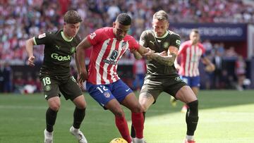 Atletico Madrid's Brazilian forward #12 Samuel Lino vies with Girona's Spanish midfielder #18 Pablo Torre and Girona's Spanish midfielder #14 Aleix Garcia during the Spanish league football match between Club Atletico de Madrid and Girona FC at the Metropolitano stadium in Madrid on April 13, 2024. (Photo by Thomas COEX / AFP)