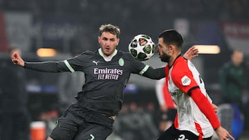 AC Milan's Mexican forward #07 Santiago Gimenez (L) fights for the ball with Feyenoord's Slovakian defender #33 David Hancko during the UEFA Champions League knockout phase play-off 1st leg football match between Feyenoord Rotterdam and AC Milan at the Stadion Feijenoord "De Kuip" in Rotterdam, on February 12, 2025. (Photo by JOHN THYS / AFP)