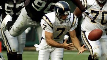 As Oakland Raiders&#039; defensive tackle Grady Jackson moves in for the tackle and San Diego Chargers&#039; offensive tackle Vaughn Parker (70) looks on, Chargers&#039; quarterback Doug Flutie (7) loses the ball momentarily on a keeper play in the second quarter at the Network Associates Coliseum, November 18, 2001. Flutie recovered his own fumble and gained three-yards on the play.    REUTERS/Lou Dematteis