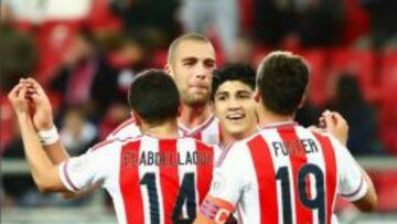 Alan Pulido es felicitados por sus compañeros luego de su anotación.