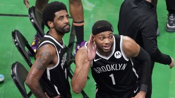 Brooklyn Nets guard Kyrie Irving, left, looks up at the fans at TD Garden while teammate Bruce Brown (1) gestures after they defeated the Boston Celtics in Game 4 during an NBA basketball first-round playoff series, Sunday, May 30, 2021, in Boston. Irving was booed and heckled by the fans all game. (AP Photo/Elise Amendola)