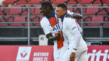 Paris Saint-Germain's Italian forward Moise Kean (L) celebrates with Paris Saint-Germain's French forward Kylian Mbappe after scoring a goal during the French L1 football match between Dijon (DFCO) and Paris Saint-Germain (PSG) at the Gaston Ger